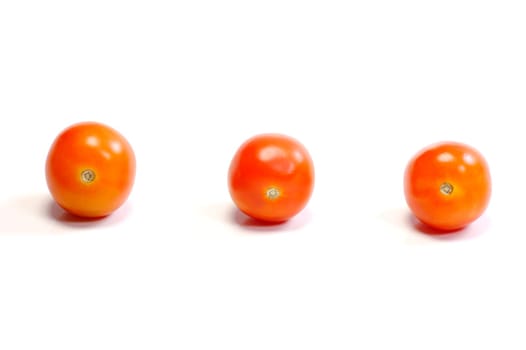 Three tomatoes on white background. Look tasty and fresh