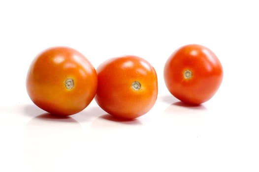 Three tomatoes on white background. Look tasty and fresh