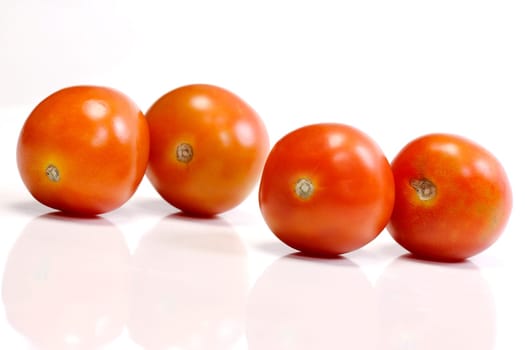 Four tomatoes on white background. Look tasty and fresh