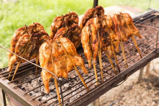 Grill chicken in bamboo stick , street food of Thailand.