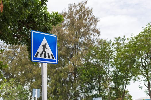 Crossing Signs Traffic yellow board blue sky with cloud background copy space concept of road safety to reduce accidents.