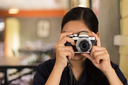 Beautiful young Asian woman in the cafe