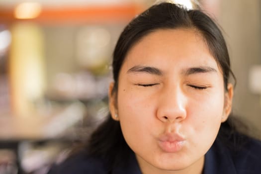 Beautiful young Asian woman in the cafe