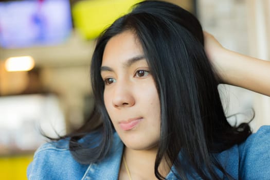 Beautiful young Asian woman in the cafe