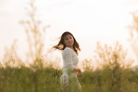 Outdoor portrait asian girl in the flowers garden