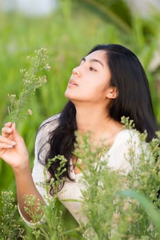 Outdoor portrait asian girl in the flowers garden
