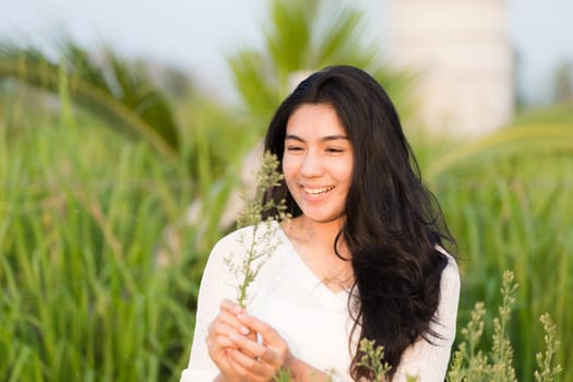 Outdoor portrait asian girl in the flowers garden