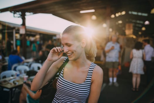 Happy young backpacker is exploring Queen Victoria Market in Australia