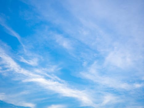 Blue sky background with tiny clouds