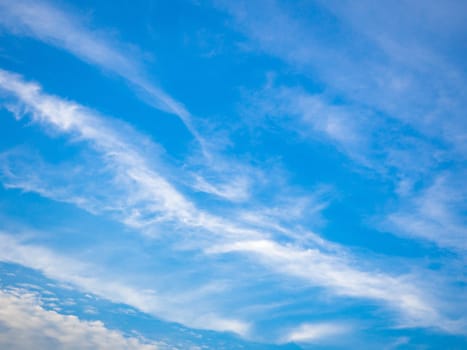 Blue sky background with tiny clouds