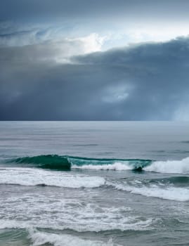 seascape image of waves on sea over stormy sky