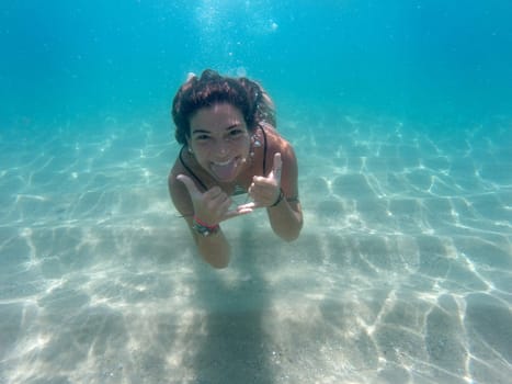 Underwater image of a happy girl diving
