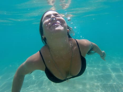 Underwater image of a happy girl diving