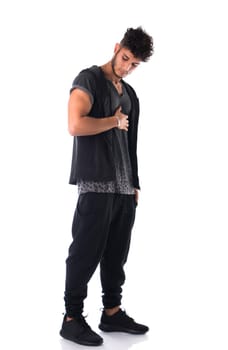 Full length shot of handsome tough young man in dark t-shirt isolated on white background, looking down