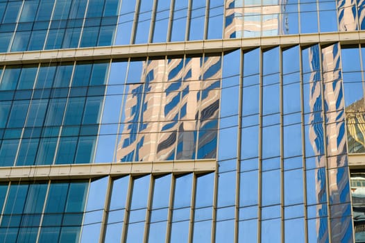 Blue office building with reflections of skyscraper