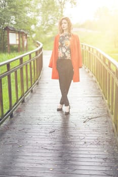 Young attractive woman after rain in nature