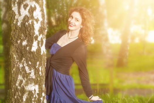 Young attractive woman after rain in nature