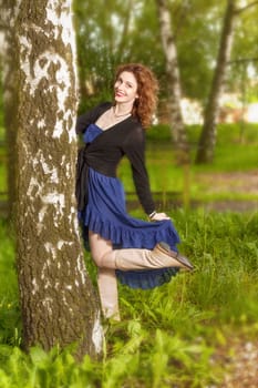 Young attractive woman after rain in nature