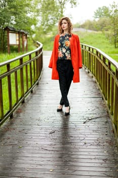 Young attractive woman after rain in nature