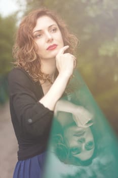 Young attractive woman after rain in nature