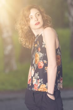 Young attractive woman after rain in nature