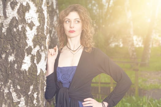 Young attractive woman after rain in nature