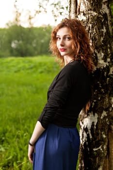 Young attractive woman after rain in nature