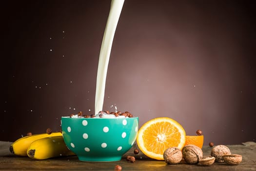 Healthy home made breakfast of muesli, apples, fresh fruits, walnuts. Served with fresh, sliced oranges.