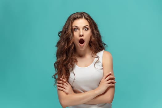 The portrait of young woman with shocked facial expression