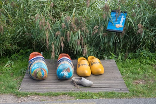 KINDERDIJK, NETHERLANDS - SEPTEMBER 18, 2016: Pair of wooden shoes for tourists to take pictures