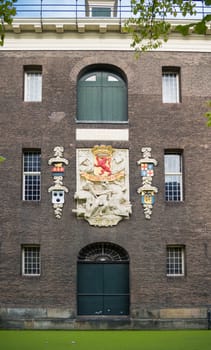 DELFT, NETHERLANDS - SEPTEMBER 18, 2016: Emblem on an old warehouse in the center of the city. The city is famous because of its association with the royal House of Orange-Nassau.