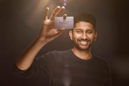 Smiling man from Sri Lanka shows business card with copyspace
