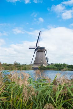 windmill along a canal in the netherlands