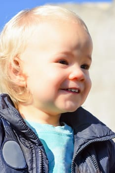 Portrait about a little smiling blonde boy.