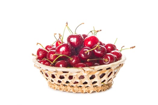 Basket with fresh cherries isolated on a white background