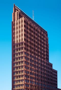View of the Kollhoff Tower in front of bleuen sky in Berlin at Potsdamer Platz.