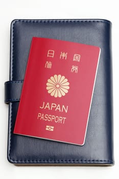 japanese passport and leather notebook isolated on white background