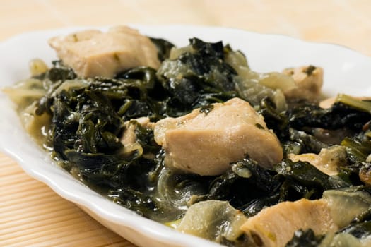 Close-up photo about chicken with mangold and spinach.