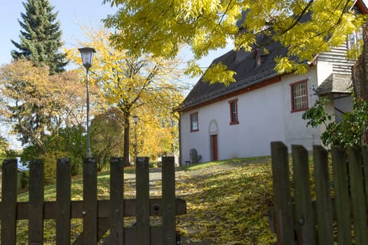 Old church in Hessian village in autumn landscape