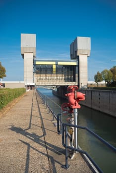 TIEL, NETHERLANDS - SEPTEMBER 24, 2016: Lock Prins Bernhard in the Amsterdam-Rhine canal, with a fire extinguisher in the foreground