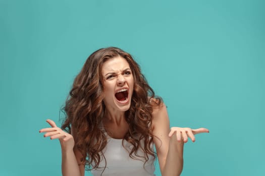 The portrait of alarmed young woman with shocked facial expression
