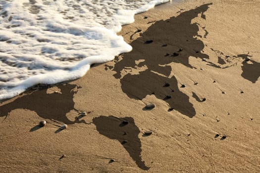 elevated view of conceptual world map on beach. Furnished NASA flat world map image used for this image.