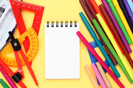 Multicolored pen, rulers and notebook