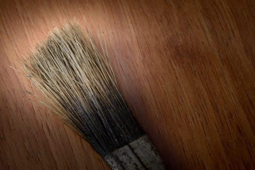 Brush tip on a wooden background