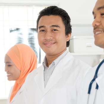 Portrait of medical team standing in hospital, Southeast Asian Muslim doctors and nurses.