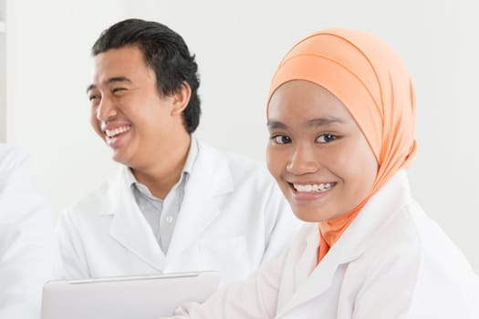 Medical team at the hospital looking very happy. Southeast Asian Muslim doctors and nurses.