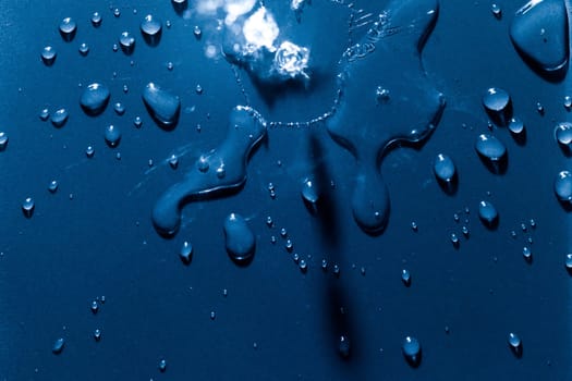 Beautiful water splashes viewed from above on a blue background