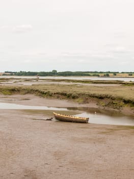 single old boat in mud sea coast no people browns