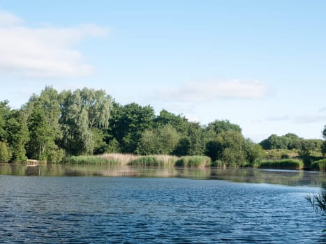 lake surface top with trees and sky outside wivenhoe essex england uk