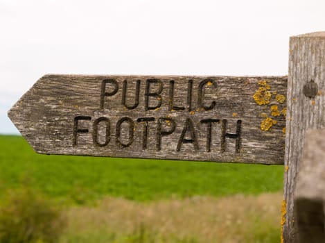 public footpath wooden sign outside leading way country